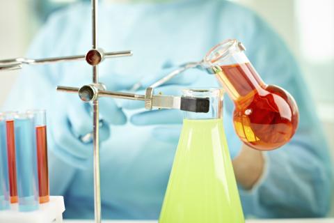 Chemicals being mixed in beakers. Photo credit: mediaphotos / Shutterstock