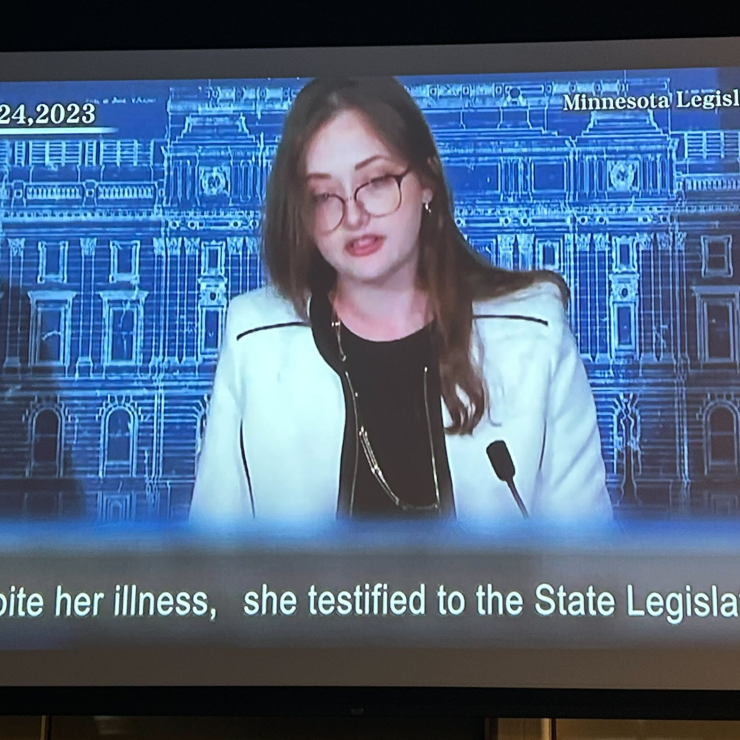 Still from film of Amara Strande, caption: "Despite her illness, she testified to the State Legislature"