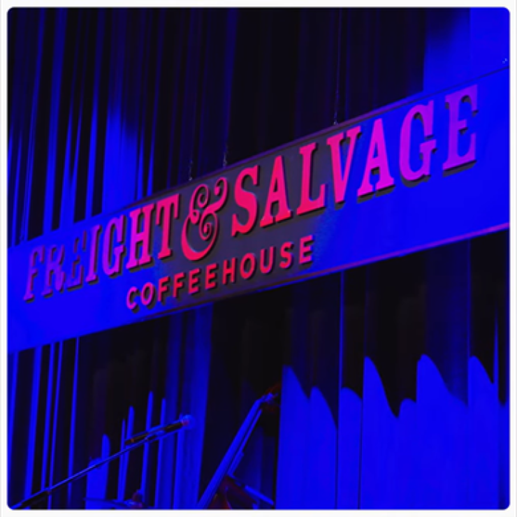 Freight & Salvage Coffeehouse stage sign lit in blue light.