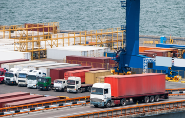 Image of trucks at a port (Canva image)