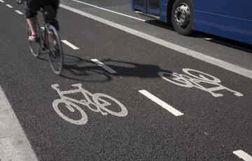Bike in a bike lane next to a bus